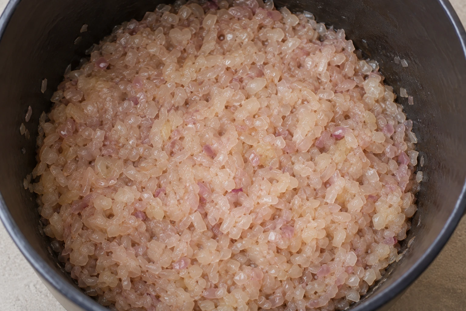 Finely chopped onions softened in a pot before fat and spices are added